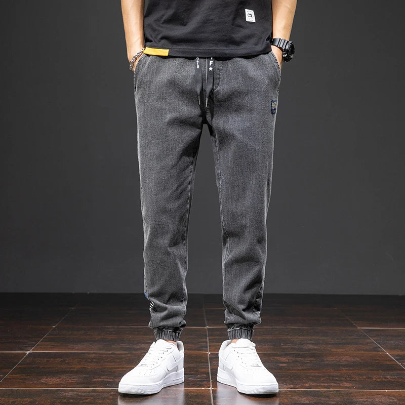 Large size elastic workwear jeans, men's ankle tied Harlan pants, wear-resistant and fat added, plus size trendy and loose