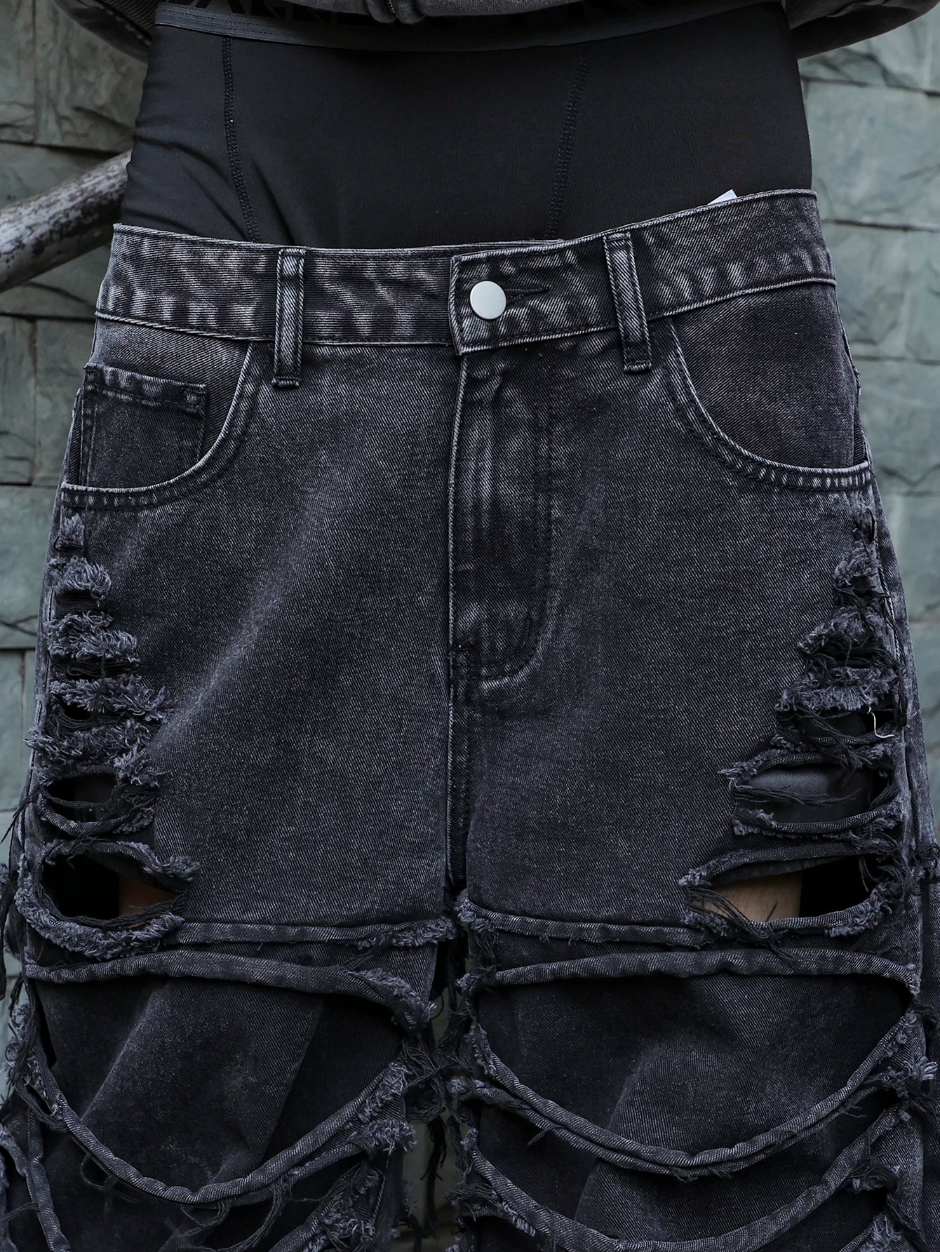 Men's black jeans. With a design of (ripped holes) and tassels. In a street trend style.
